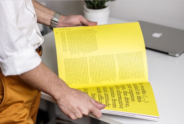 designer-flipping-through-yellow-magazine-img-D